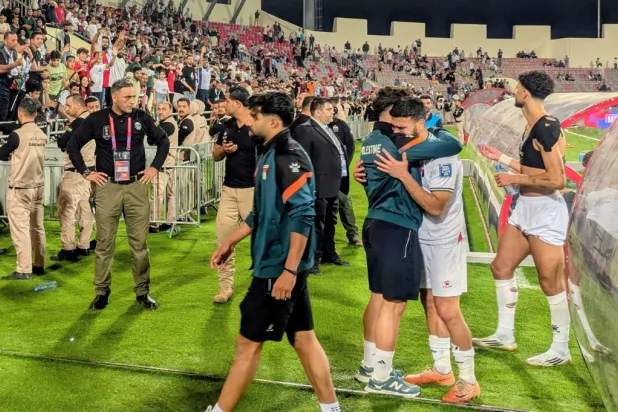 File: Palestinian players leave the field after an Asian Group B World Cup qualifying soccer match against Oman at the King Abdullah II Stadium in Amman, Jordan on June 12, 2025. (AP Photo/John Duerden)