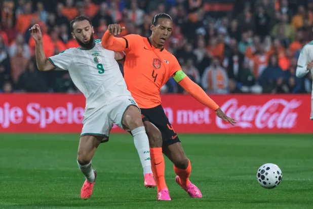 Algeria's Amine Gouiri, left, challenges for the ball with Netherlands' Virgil van Dijk during the international friendly soccer match between Netherlands and Algeria in Rotterdam, Netherlands, Wednesday, June 3, 2026. (AP Photo/ Patrick Post)