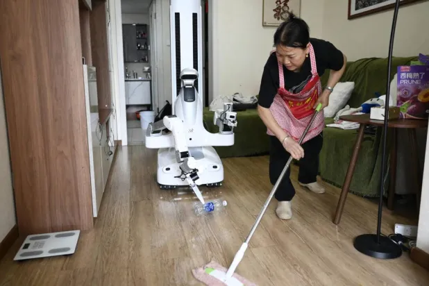 The service is a baby step towards a future in which robots increasingly take over manual labor from humans. WANG Zhao / AFP
