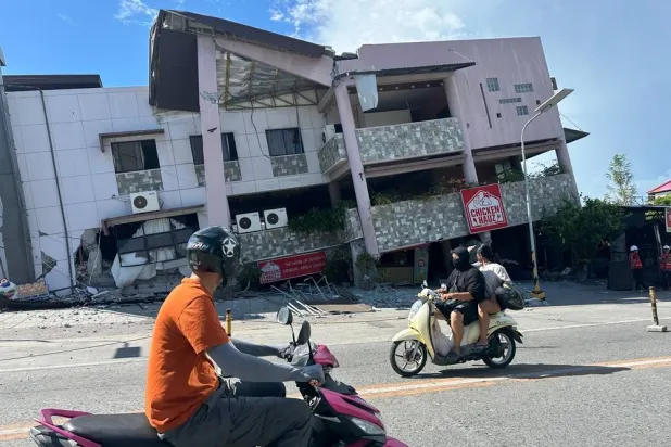  Residents pass by a collapsed structure after an earthquake in General Santos, Philippines on Monday, June 8, 2026. (AP) 