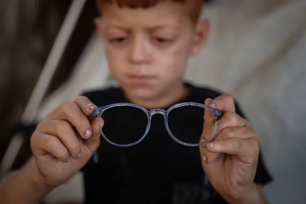Ayoub holding his damaged glasses on 2 June. Photograph: Anadolu/Getty Images