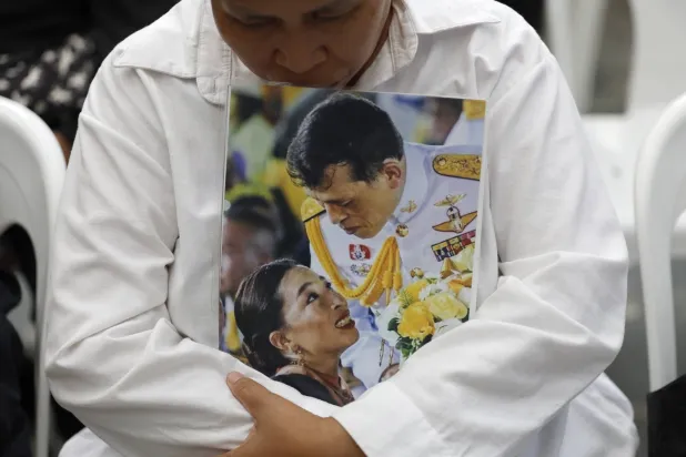 A Thai woman mourns while holding a photograph of Thai King Maha Vajiralongkorn (R) and his daughter Princess Bajrakitiyabha (L) following the announcement of her death at King Chulalongkorn Memorial Hospital in Bangkok, Thailand, 12 June 2026. EPA/RUNGROJ YONGRIT
