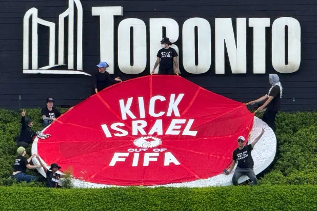 ]Protesters hold a banner reading "Kick Israel Out of FIFA", ahead of Canada's World Cup match against Bosnia and Herzegovina in Toronto, Ontario, Canada, June 12, 2026. (Reuters)