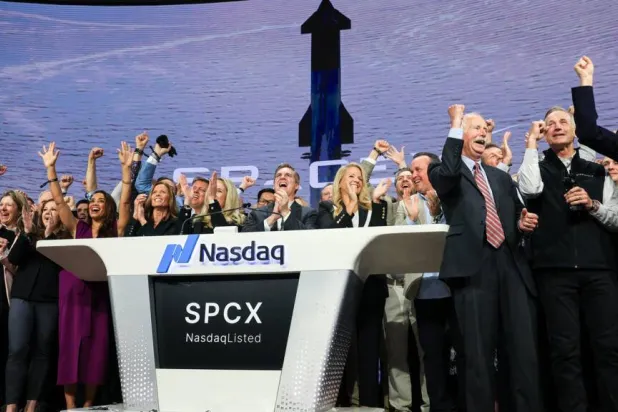 SpaceX employees celebrate the company's Wall Street debut, the largest initial public offering in US history. TIMOTHY A. CLARY / AFP
