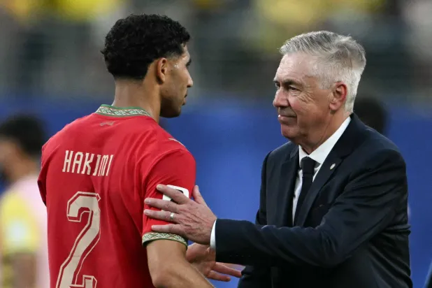 Brazil's Italian head coach Carlo Ancelotti greets Morocco's defender #02 Achraf Hakimi at the end of the 2026 World Cup Group C football match between Brazil and Morocco at the New York/New Jersey Stadium in East Rutherford on June 13, 2026. (Photo by Mauro PIMENTEL / AFP)
