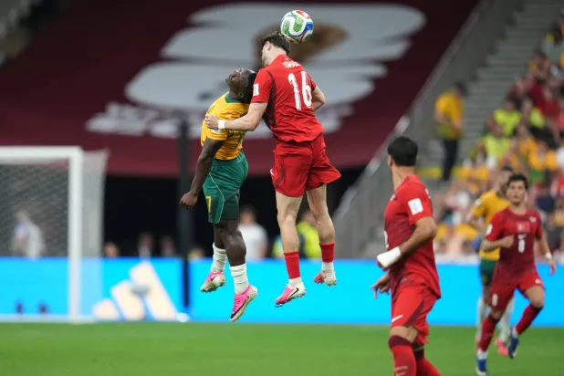 Australia's Nestory Irankunda (17) and Türkiye's Ismail Yuksek (16) jump to head the ball during the World Cup Group D soccer match between Australia and Türkiye in Vancouver, British Columbia, Saturday, June 13, 2026. (AP Photo/Abbie Parr)