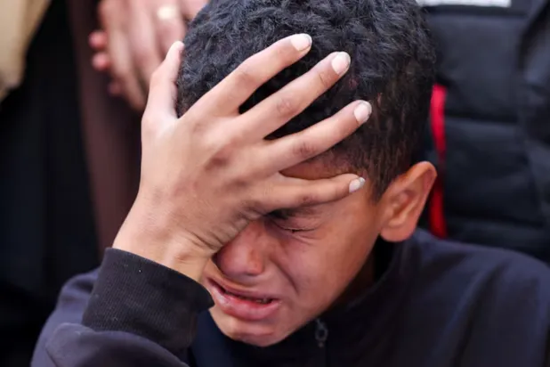 A boy reacts during the funeral of Palestinians who, according to medics, were killed in an Israeli strike, in Gaza City, March 30, 2026. REUTERS/Dawoud Abu Alkas 