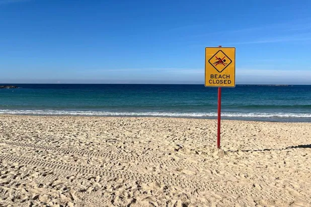 A beach closed sign is displayed at Coogee Beach in Sydney on June 13, 2026. (AFP)