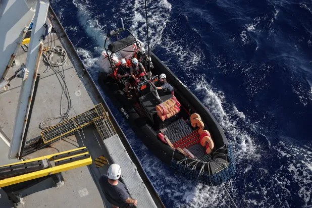 طاقم سفينة بحث وإنقاذ يطلق قارباً مطاطياً بوسط البحر المتوسط قبالة سواحل ليبيا في عملية إنقاذ لمهاجرين يوم 10 أغسطس 2025 (رويترز)