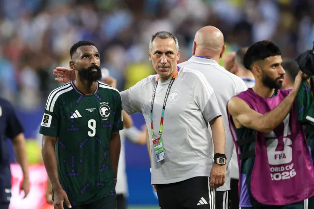  Saudi Arabia's Greek head coach Giorgos Donis talks to his forward #09 Feras Al-Brikan at the end of the 2026 World Cup Group H football match between Saudi Arabia and Uruguay at the Miami Stadium in Miami Gardens on June 15, 2026. (AFP)