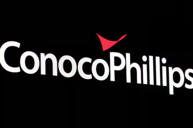 A screen displays the logo for ConocoPhillips on the floor of the New York Stock Exchange (NYSE) in New York City, US, April 6, 2022. REUTERS/Brendan McDermid