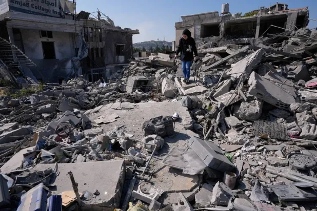  Sukaina al-Muhtadi, 22, who returned to her village following the announcement of an initial ceasefire agreement between the United States and Iran, search for her belongings between the rubble of her destroyed house in Nabatieh town, southern Lebanon, Tuesday, June 16, 2026. (AP) 