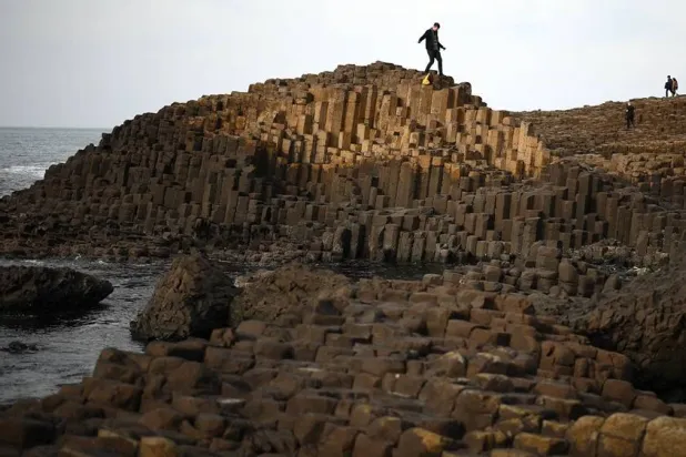 People explore the basalt columns of the Giant’s Causeway on Northern Ireland’s north coast on March 20, 2025. (AFP via Getty Images) 