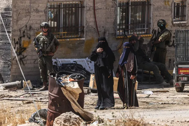  Israeli soldiers stand by as Palestinian women look on as Israeli bulldozers demolish a Palestinian home, which the Israeli authorities say was built without permission, in Ar-Rifaiyya village, south of the Israeli-occupied Palestinian West Bank city of Hebron on June 17, 2026. (AFP)
