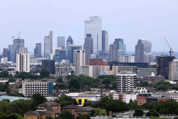 Skyscrapers and office buildings in the City of London are pictured from Hampstead Heath in north London on June 18, 2026. (Photo by Toby Shepheard / AFP)