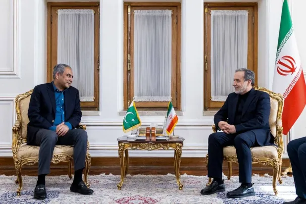 In this photo, released by the Iranian Foreign Ministry, Foreign Minister Abbas Araghchi, right, meets Pakistan's Interior Minister Mohsin Naqvi, in Tehran, Iran, Saturday, June 20, 2026. (Iran's Foreign Ministry, via AP)