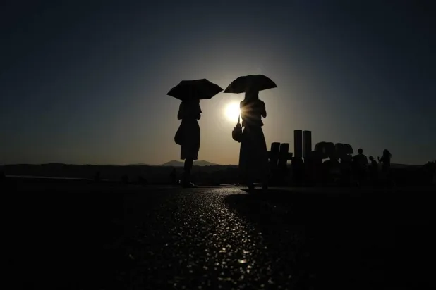 Two women walk in front of the sea at the beginning of the "Promenade des Anglais" on the French riviera city of Nice, on June 20, 2026. (AFP)