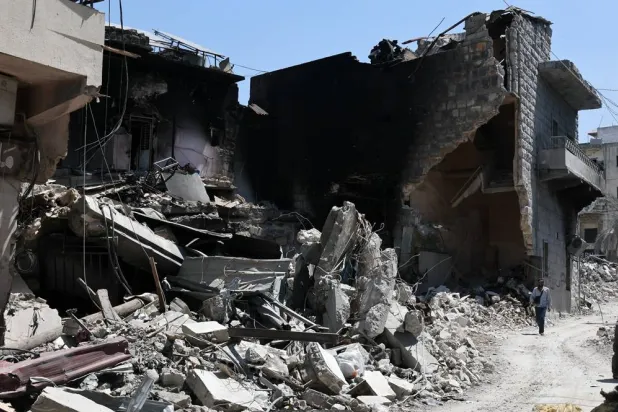 A man walks past a destroyed building targeted by Israeli air strikes on the historic old market in the town of Nabatieh, southern Lebanon, 21 June 2026, following the ceasefire between Israel and Hezbollah. (EPA)