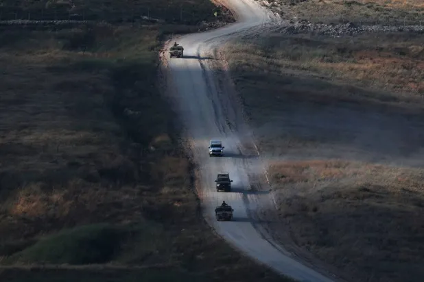 Israeli military vehicles maneuver on the Lebanese side of the Israel-Lebanon border, as seen from the Upper Galilee, in northern Israel, 21 June 2026. (EPA)