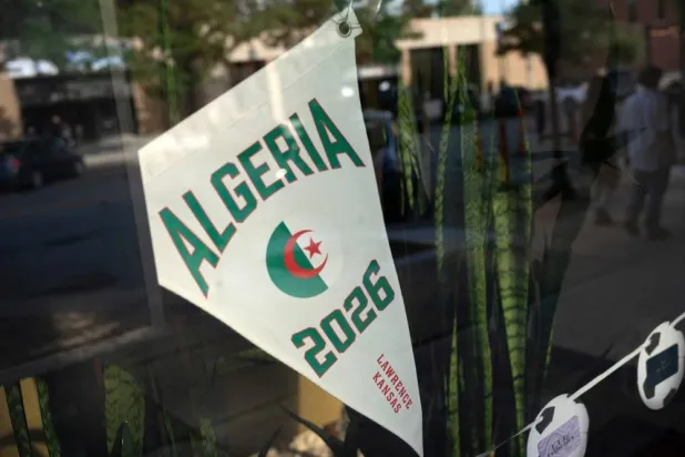 A pennant of Algeria, whose home base for the 2026 World Cup tournament is at the nearby University of Kansas, is displayed in a shop window before the game against Argentina, in Lawrence, Kansas, US, June 16, 2026. (Reuters) 