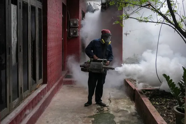 A worker from the Medical Officer of Health (MOH) department fumigates a residential area during a mosquito control program in Colombo, Sri Lanka, June 19, 2026. (Reuters)