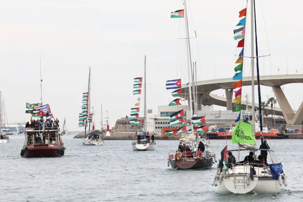 Boats of a new humanitarian flotilla bound for the Gaza Strip make a symbolic leave from Barcelona's Port Vell on April 12, 2026 as the departure of the flotilla has been postponed due to bad weather. (AFP)