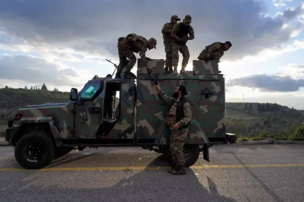 Syrian army personnel on a military vehicle in Deir Hafer, rural Aleppo, in January 2026. (Reuters)

