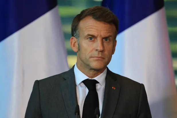 France's President Emmanuel Macron addresss the press at the end of the meeting of state leaders of the European Group of Five (E5) and the NATO Secretary General, on June 24, 2026 at the Chancellery in Berlin, Germany. (Photo by Ludovic MARIN / AFP)