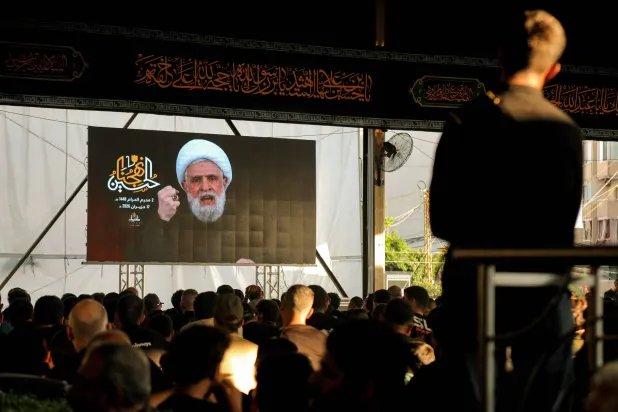 17 June 2026, Lebanon, Beirut: Hezbollah Secretary-General Naim Qassem addresses crowds via a giant screen during the first day of Ashoura at the shrine of former Hezbollah leader Hassan Nasrallah in Beirut southern suburb. Photo: Marwan Naamani/dpa