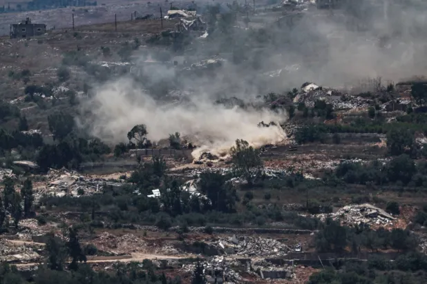 Israeli tank manoeuvres as United Nations Interim Force in Lebanon (UNIFIL) convoy drive between destroyed houses in the south Lebanon village of Meiss El Jabal, as seen from the Israeli side of the border in the upper Galilee, 26 June 2026.  EPA/ATEF SAFADI
