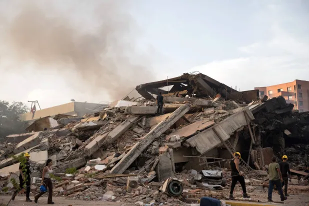A man searches for survivors in the rubble of a collapsed building following twin earthquakes in Caraballeda, La Guaira State, some 40 km northeast of Caracas, on June 25, 2026. (AFP)