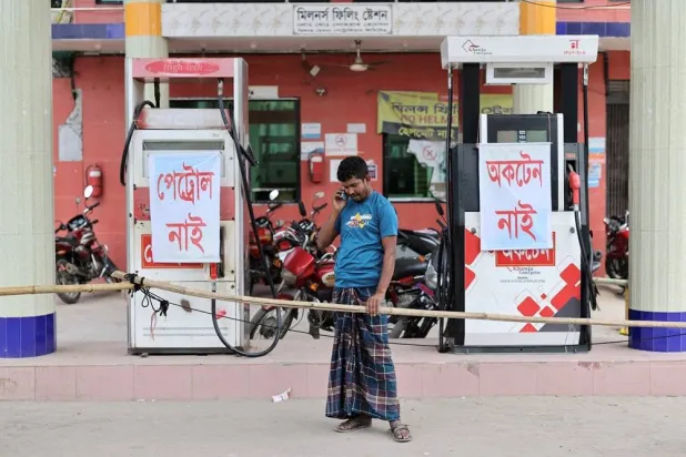 Mohammad Yusuf, a farmer, speaks on his phone as he arrives at a fuel station to buy diesel to irrigate his paddy field, but finds none available amid a fuel crisis, in Manikganj, Bangladesh, April 8, 2026. (Reuters)