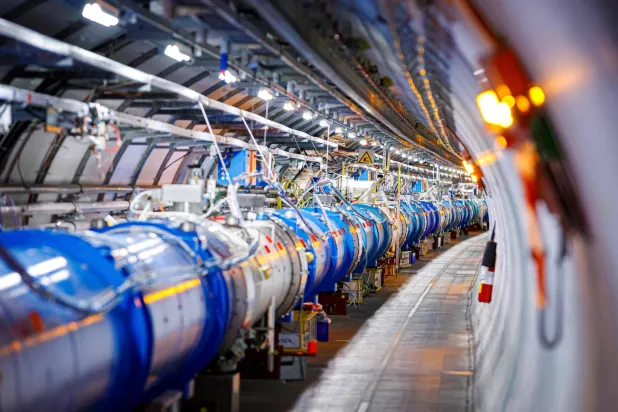 Some of the 1232 dipole magnets that bend the path of accelerated protons are pictured in the Large Hadron Collider (LHC) in a tunnel of the European Organization for Nuclear Research (CERN), during maintenance works on February 6, 2020 in Echenevex, France, near Geneva. (AFP)