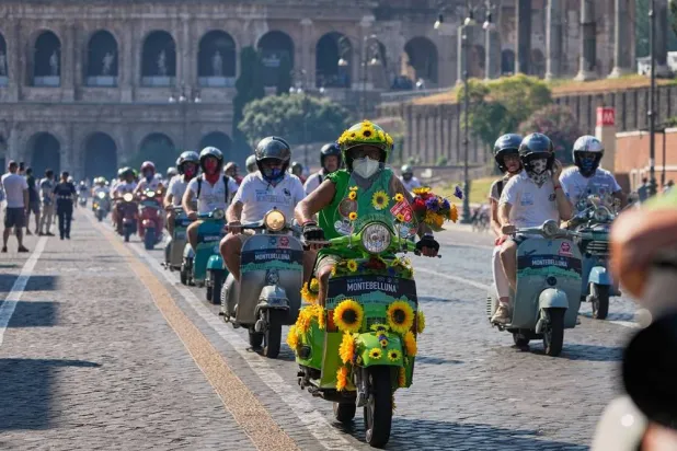  Vespa enthusiasts parade in front of the Colosseum during celebrations for the 80th anniversary of the Vespa scooter, in Rome, Saturday, June 27, 2026. (AP)