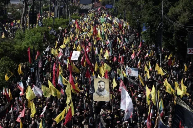 Hezbollah supporters wave flags during a march marking Ashura in Beirut’s southern suburbs (EPA)