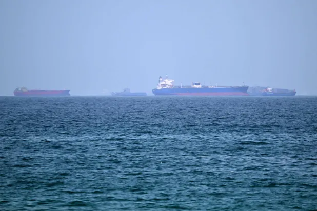 Cargo ships are pictured off the coast of the Khor Fakkan Container Terminal, the only natural deep-sea port in the region and one of the major container ports in Sharjah Emirate, along the Gulf of Oman on June 28, 2026. (Photo by AFP)