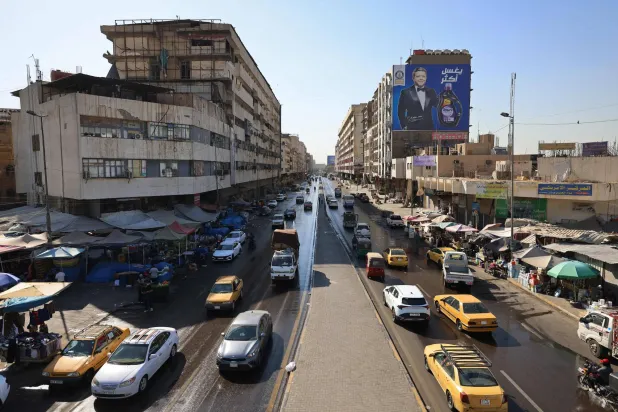  Vehicles drive along the Al-Jumhuri street in central Baghdad on June 28, 2026. (AFP)