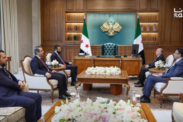 Syrian President Ahmed al-Sharaa receives Iraqi FM Fuad Hussein in Damascus on Monday. (SANA)