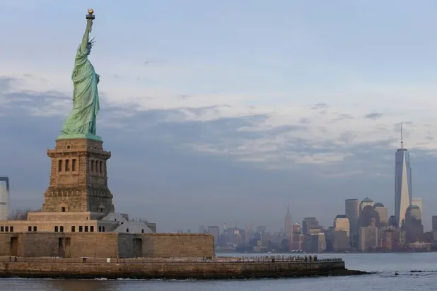 The lower Manhattan skyline, including the new One World Trade Center building at right, is shown as viewed from near the Statue of Liberty, Jan. 31, 2014, in New York.  (AP)