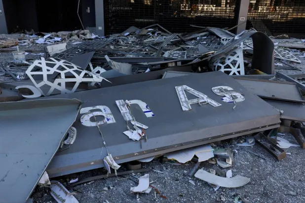 Debris lies at the site of a damaged branch of Al-Qard Al-Hassan, a financial institution linked to Lebanon's Hezbollah, in the aftermath of Israeli airstrikes that hit several branches of the institution, amid the ongoing hostilities between Hezbollah and Israeli forces, in Beirut suburbs, Lebanon, October 21, 2024. (Reuters)
