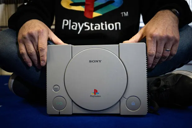 French PlayStation' collector Cyril, poses with a PlayStaion 1, at his home in Vraiville, on November 20, 2024. (AFP)