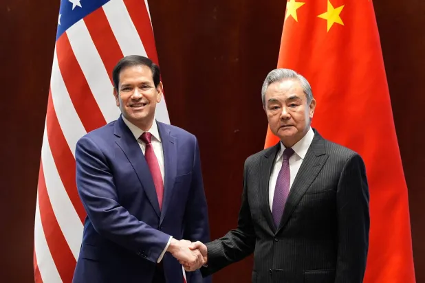  US Secretary of State Marco Rubio (L) shakes hands with China's Foreign Minister Wang Yi in Munich, on February 12, 2026. (AFP/Getty Images)