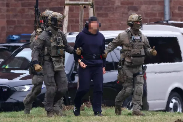 Polis, şüpheli Serhiy Kuznetsov'u Alman Federal Savcısı ile yapılan duruşmanın ardından helikoptere bindirirken eşlik etti (Reuters)