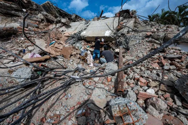 This photograph taken on July 2, 2026 in Caraballeda in the state of La Guaira shows volunteers looking for survivors in a collapsed building following the June 24 twin earthquakes. (AFP)