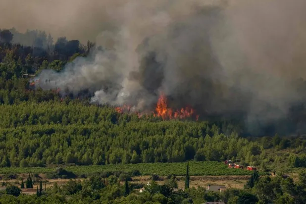 This photograph shows a fire in mountain ranges during a wildfire in Pouzols-Minervois, southwestern France on July 2, 2026. (AFP)