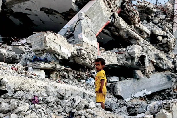 A child amid the rubble of a building destroyed by Israel in Al-Shati camp, west of Gaza City, last Wednesday. (AFP)