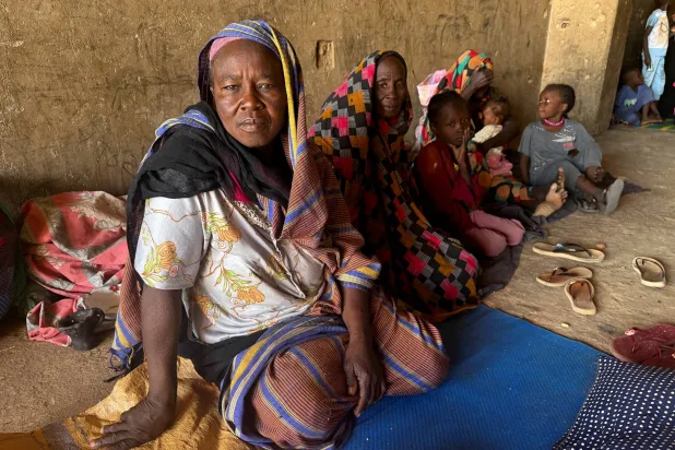 FILE PHOTO: Displaced women from South Kordofan sit on the ground in El Obeid, North Kordofan State, Sudan, January 15, 2026. REUTERS/El Tayeb Siddig/File Photo