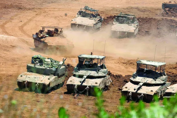 This picture taken from a position in the Upper Galilee in northern Israel shows Israeli army tanks positioned along the Israel-Lebanon border, on July 1, 2026. (Photo by Jack GUEZ / AFP) / 