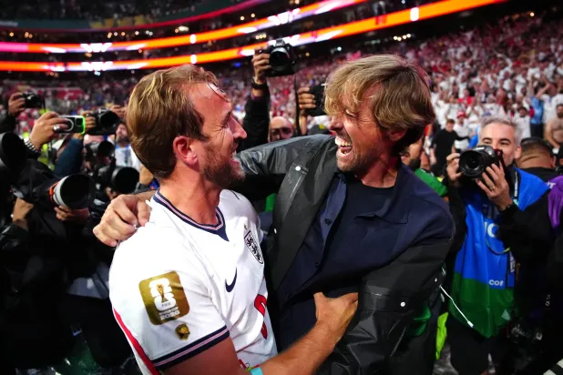 هاري كين لاعب المنتخب الإنجليزي يحتفل مع اللاعب السابق بيتر كراوتش عقب الفوز (د.ب.أ)
