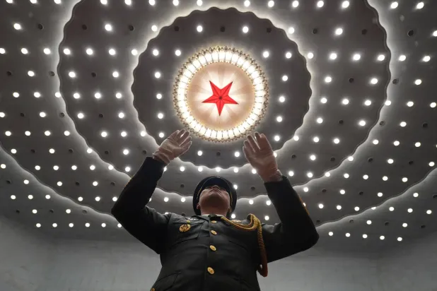 A military band conductor leads during a ceremony to mark the 105th anniversary of the founding of the Chinese Communist Party at the Great Hall of the People in Beijing, Wednesday, July 1, 2026. (AP Photo/Ng Han Guan)